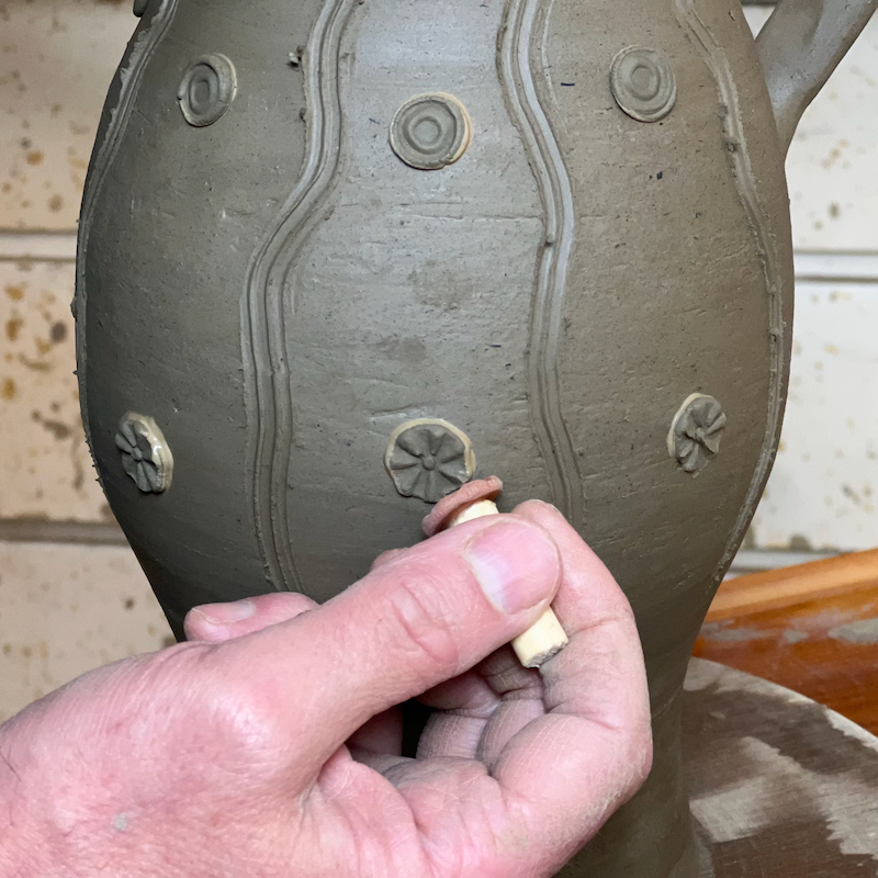Impressing roundels on a medieval style jug