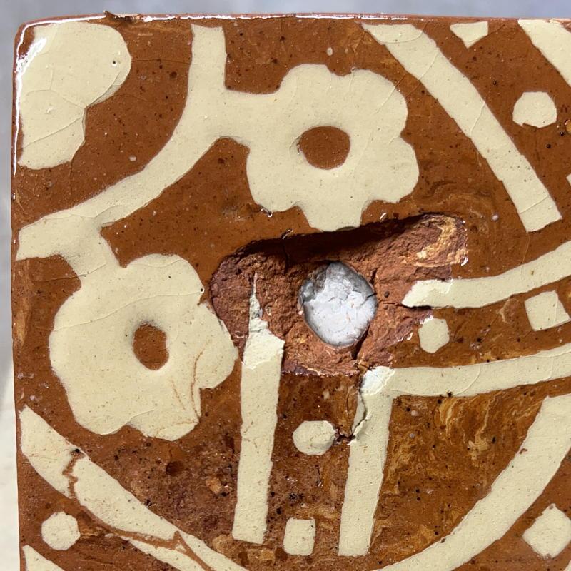 tile damaged by fracturing stone during firing