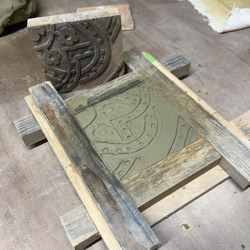 Tile stamped while in the mould