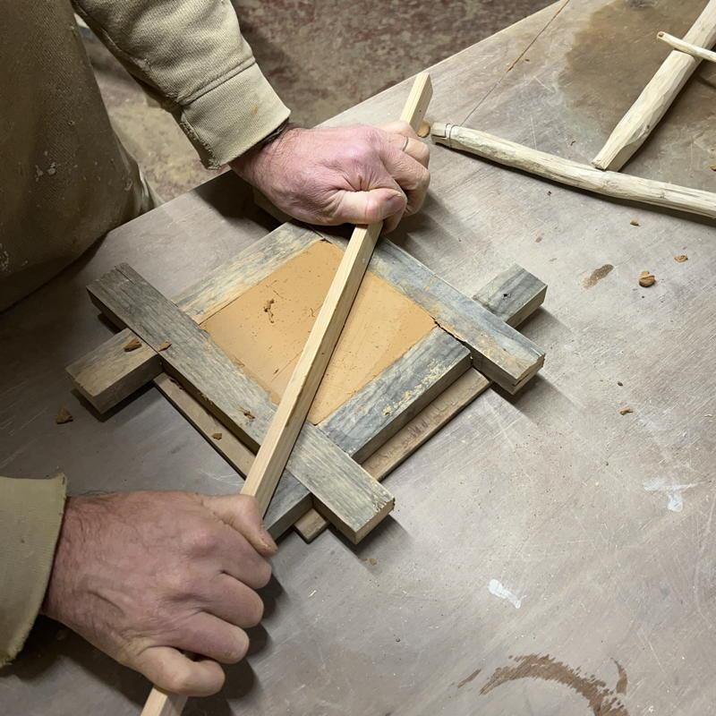 Tile surface being levelled with a strike
