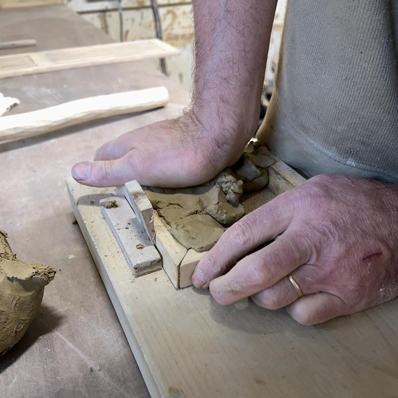 piecemeal filling the clay mould