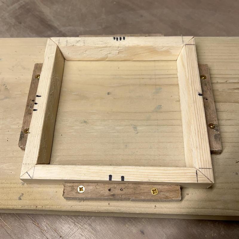 four piece mould held in place by blocks on board